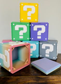 four different colored blocks with question marks on them