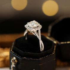 a close up of a diamond ring in a box