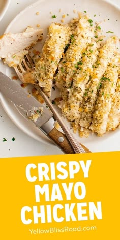 crispy mayo chicken on a white plate with a fork and knife next to it