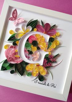 the letter c is made out of paper and decorated with flowers