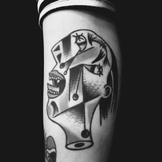 a black and white photo of a person's leg with tattoos on it,