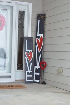 two wooden love signs on the front porch