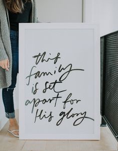 a woman standing next to a sign that says, this family is set apart for his glory