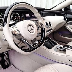 the interior of a car with steering wheel, dashboard and gauges on each side