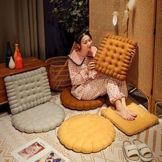 a woman is sitting on the floor with an inflatable chair and other items