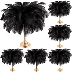 six black ostrich feathers on brass bases, each with different sizes and shapes