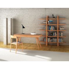 a wooden desk sitting in front of a book shelf