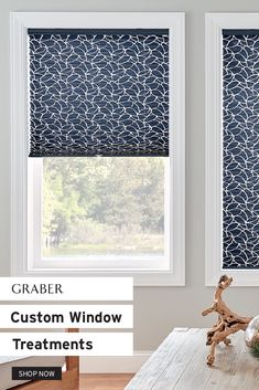 two windows with blue and white patterned blinds in the living room, one window is closed