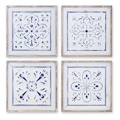 four blue and white tiles with designs on them