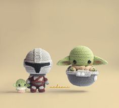 two crocheted yoda and baby yoda dolls, one holding an infant yoda