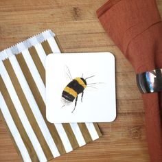 a yellow and black bee sitting on top of a white plate