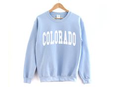 Colorado Crewneck Sweatshirt ❀ Long sleeve crewneck sweatshirt. ❀ Design is printed directly to the sweatshirt. ❀ Unisex sizing, size up if you want an oversized fit. ❀ For garment measurements, please take a look at the size guide included in the images. Washing instructions to best preserve the print: ❀ Wash inside out using mild detergent, on a low temperature setting.  ❀ Let hang dry (do not tumble dry). Shop Homepage: https://www.etsy.com/shop/peachleafstore/ Have any questions? Feel free t Cute Sweaters Teens, Cute Sweaters For Teen, Teenager Sweaters, Gifts For Teens 2022, Hawaii Shirt Women, Malibu Shirt, Malibu Sweatshirt, Miami Shirt, Colorado Shirt