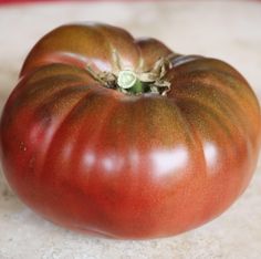 a large tomato sitting on top of a table