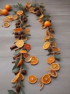 orange slices and pine cones are arranged on a table