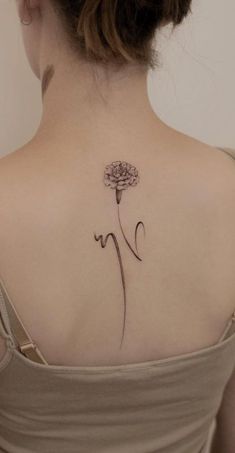 a woman with a flower tattoo on her back