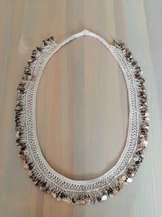 a white necklace with lots of beads on it