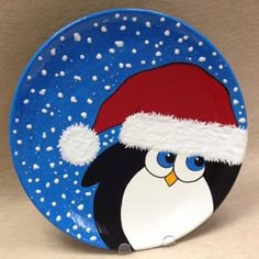 a plate with a penguin wearing a santa hat