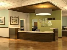 an empty office with wood floors and green walls