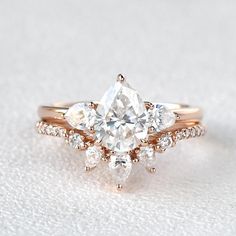 an engagement ring with three pear shaped diamonds