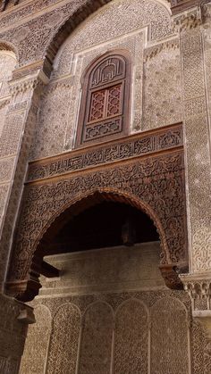 an intricately carved archway in the middle of a building with stonework on it