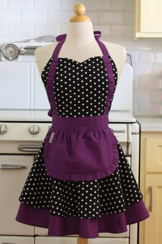 a dress on a mannequin in front of a stove top with white and black polka dots