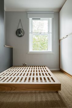 a bed sitting under a window in a bedroom