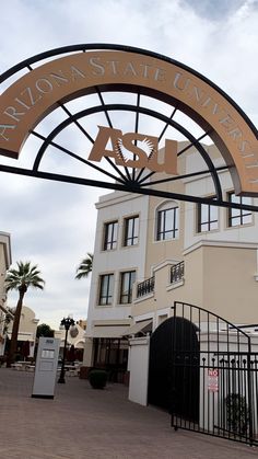 the entrance to arizona state university with an arch over it and palm trees in the background