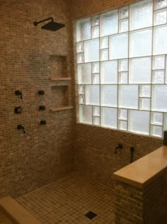 a bathroom with a walk in shower next to a window