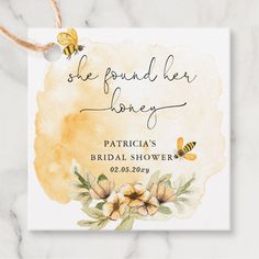 the bridal shower sign is shown on a marble surface with flowers and a bee