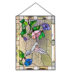 a stained glass window with flowers and leaves on the outside, hanging from a chain