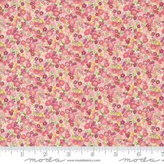 pink and yellow flowered fabric with white trim on the bottom, in front of a ruler