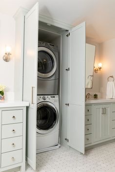 a washer and dryer are in the closet