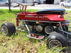 a red and black motorcycle sitting in the grass