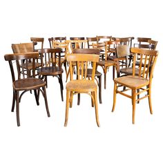 a bunch of wooden chairs sitting next to each other