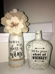 two decorative bottles sitting on top of a counter