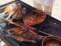 some meat is being cooked on a grill