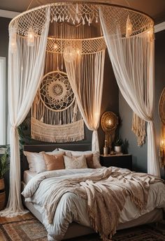 a bedroom with a canopy bed and white drapes hanging from it's ceiling