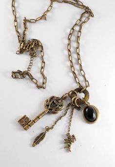 "For sale is a vintage skeleton key necklace. This necklace is brass with a skeleton key, feather, cupid, and a black cabochon. The chain measures 30\". The skeleton key pendant measures 2 1/4\". This is a gorgeous vintage fashion steampunk necklace that will look great with almost any outfit! New treasures added all the time. Check back often!" Vintage Brass Necklaces With Two Keys, Vintage Metal Jewelry With Keys Detail, Vintage Metal Jewelry With Keys, Vintage Metal Key Jewelry, Bronze Brass Necklace With Keys, Vintage Metal Jewelry With Two Keys, Vintage Gold Key Necklace, Vintage Gold Necklaces With Keys, The Skeleton Key