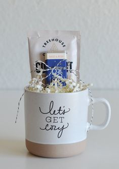 a coffee cup filled with lots of white and blue stuff next to a bag of chips