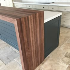 a kitchen counter top sitting next to a sink in a room with tile flooring