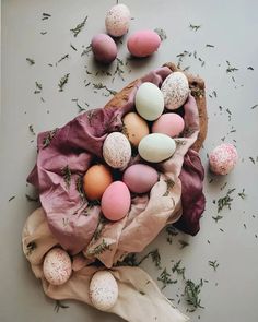 an arrangement of eggs and herbs on a table