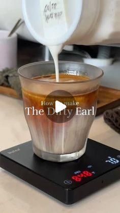 a cup filled with liquid sitting on top of a scale