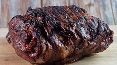 a piece of meat sitting on top of a wooden cutting board