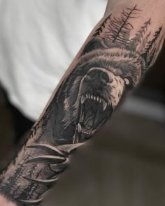 a man with a bear tattoo on his arm