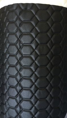 black leather textured with white stitching on the bottom part of a lamp shade