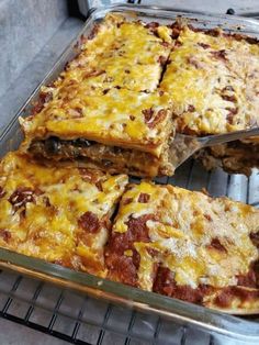 several slices of pizza sitting on top of a metal tray in an oven with one slice missing