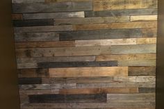 a bathroom with wood planks on the wall