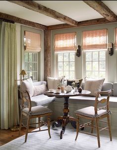 a living room filled with furniture and windows