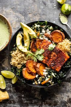 a bowl filled with meat and vegetables next to guacamole