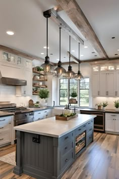 a large kitchen with an island in the middle and lots of lights hanging from the ceiling